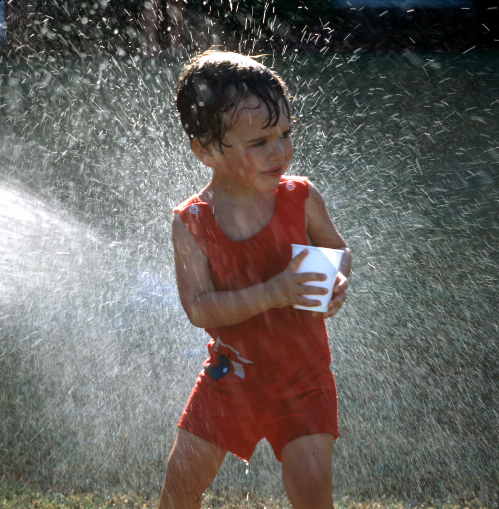 Little guy in a sprinkler