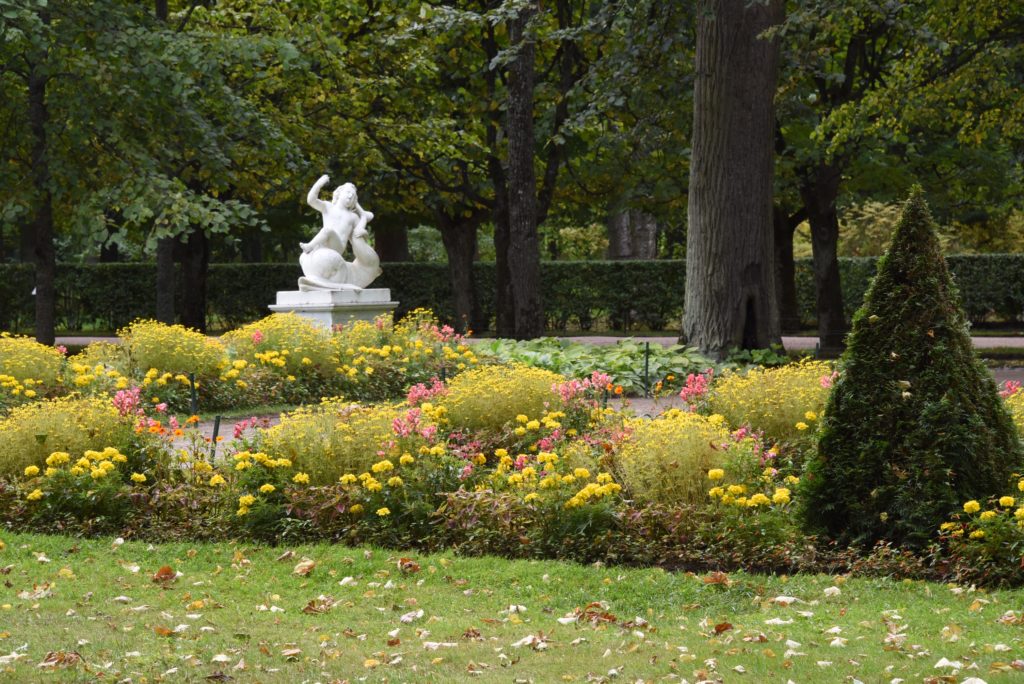 statue with flowers and tree