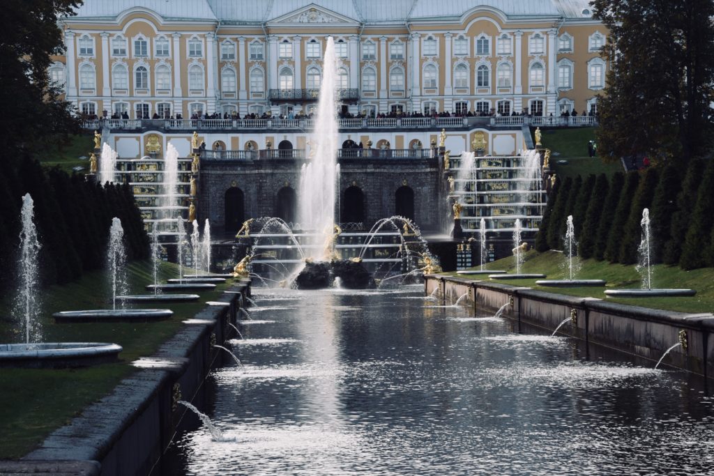 front view of gold statues and water fountain