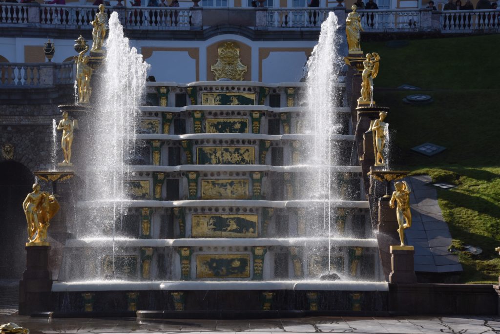 stairs surrounded by gold statues