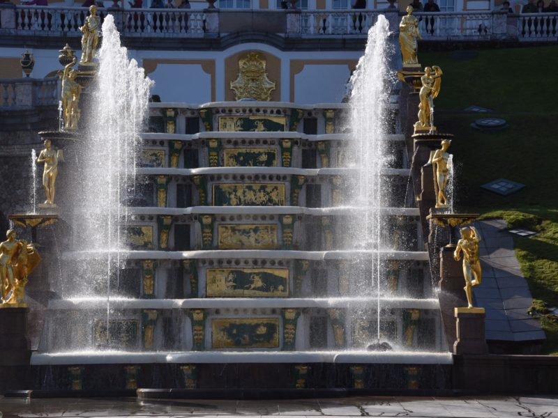 stairs surrounded by gold statues