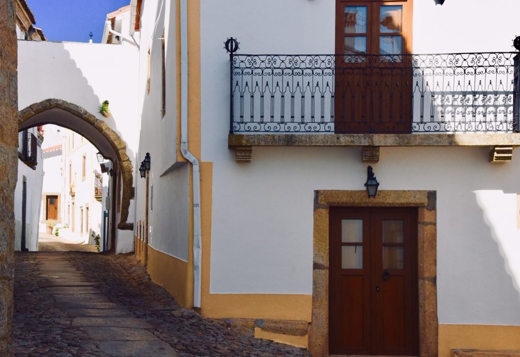 orange and white building with wooden doors