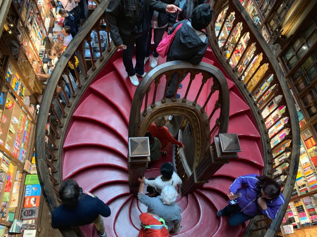 people walking down spiral stair case